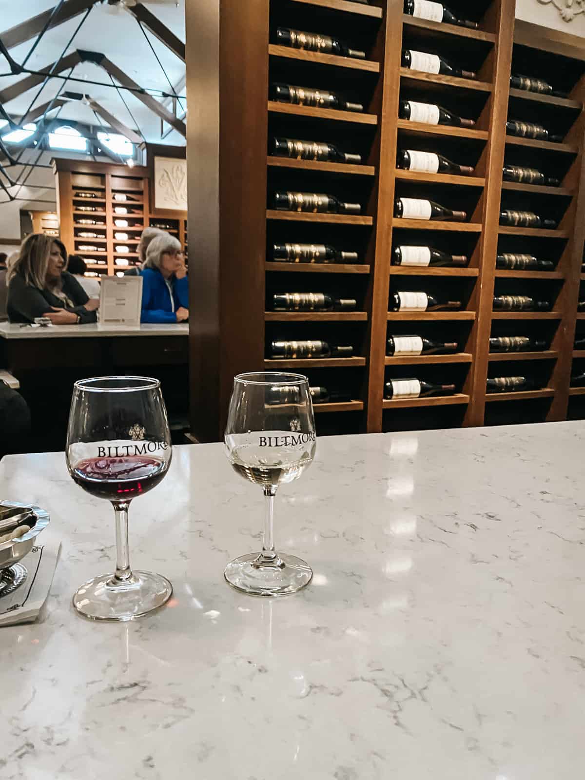 A white counter with two glasses of wine on it inside the tasting room at the Biltmore Winery