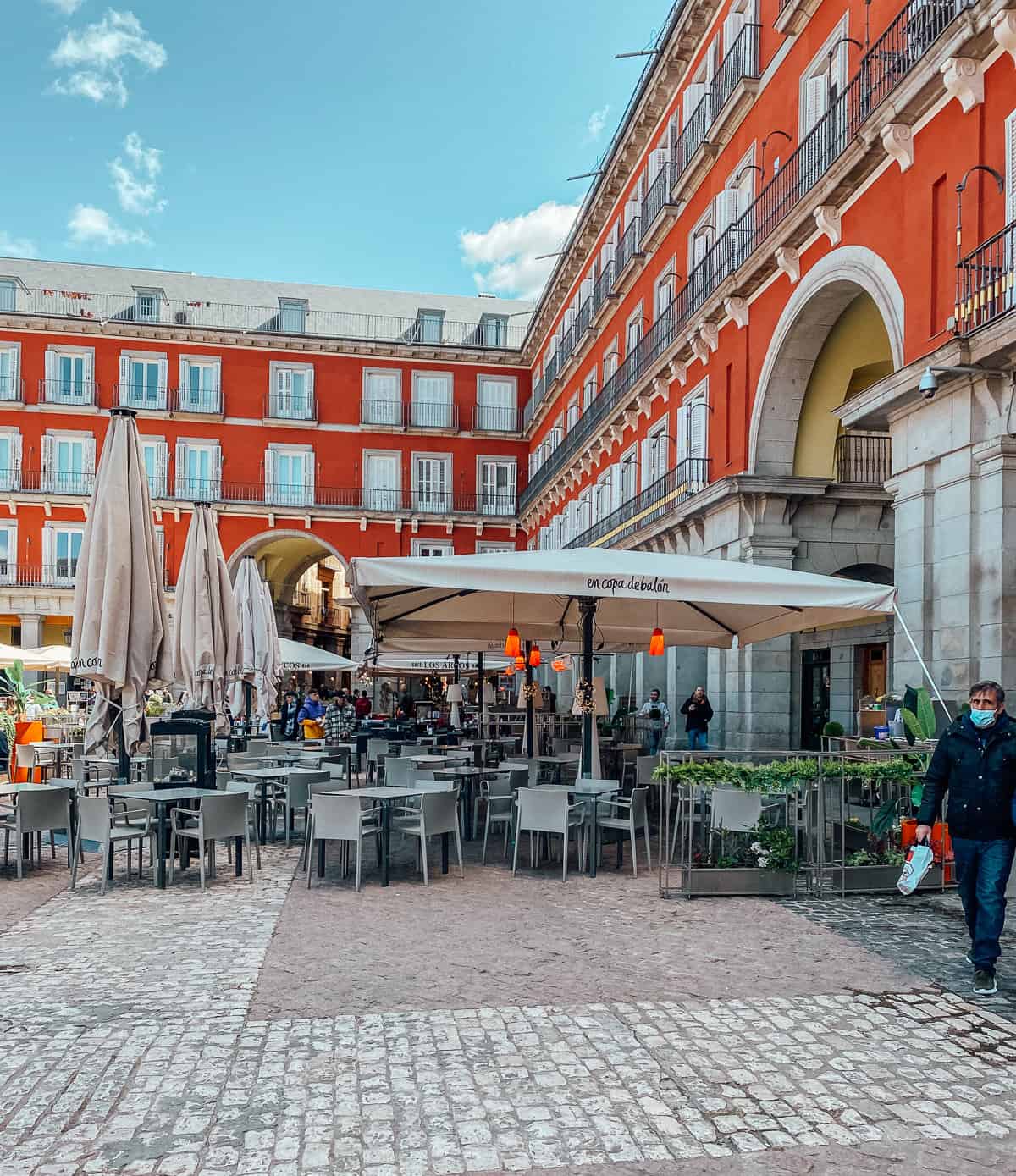 A busy plaza with restuarnats, tables and chairs in Spain madrid