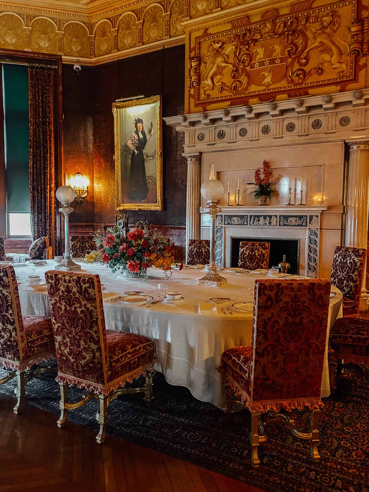 an old dining room in the Biltmore Estate with gold and red furniture