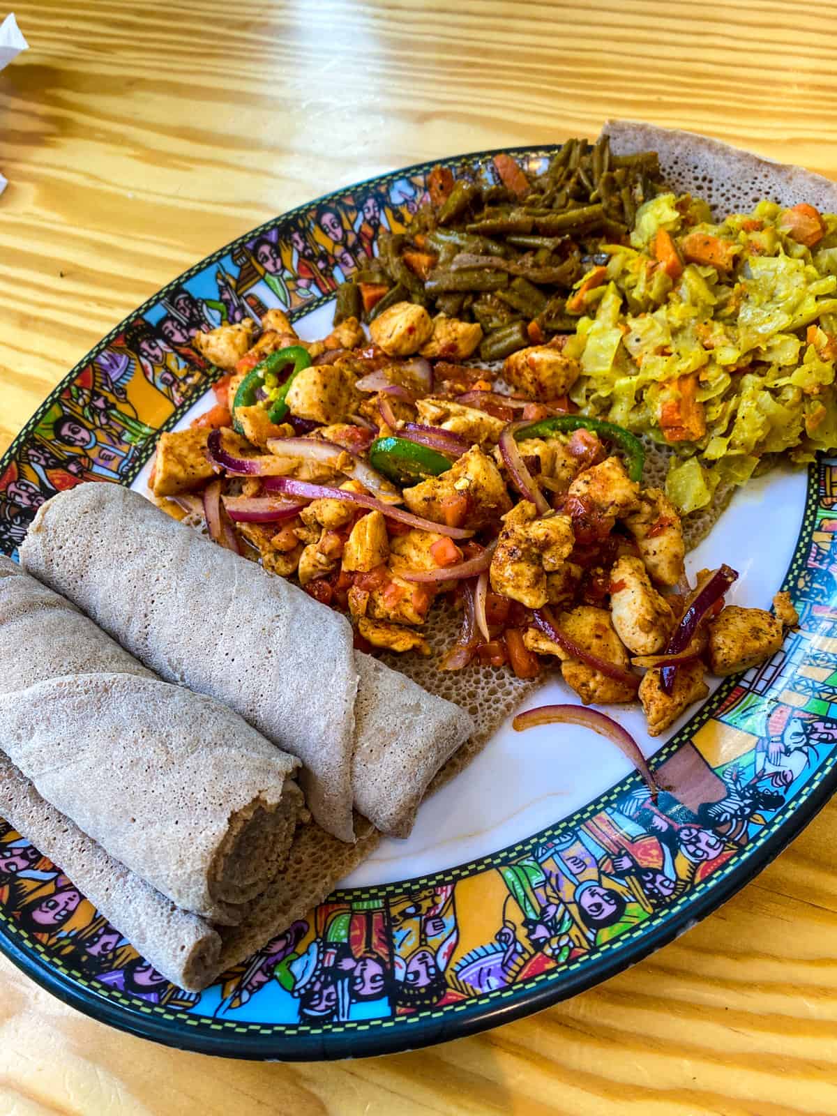 Ethiopia food on a bright, colorful patterned plate