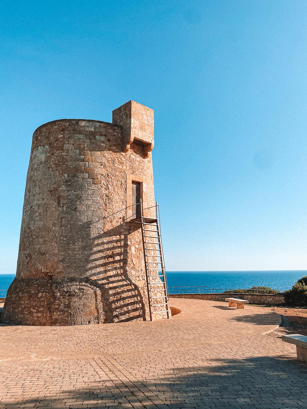 an old stone tower overlooking the ocean