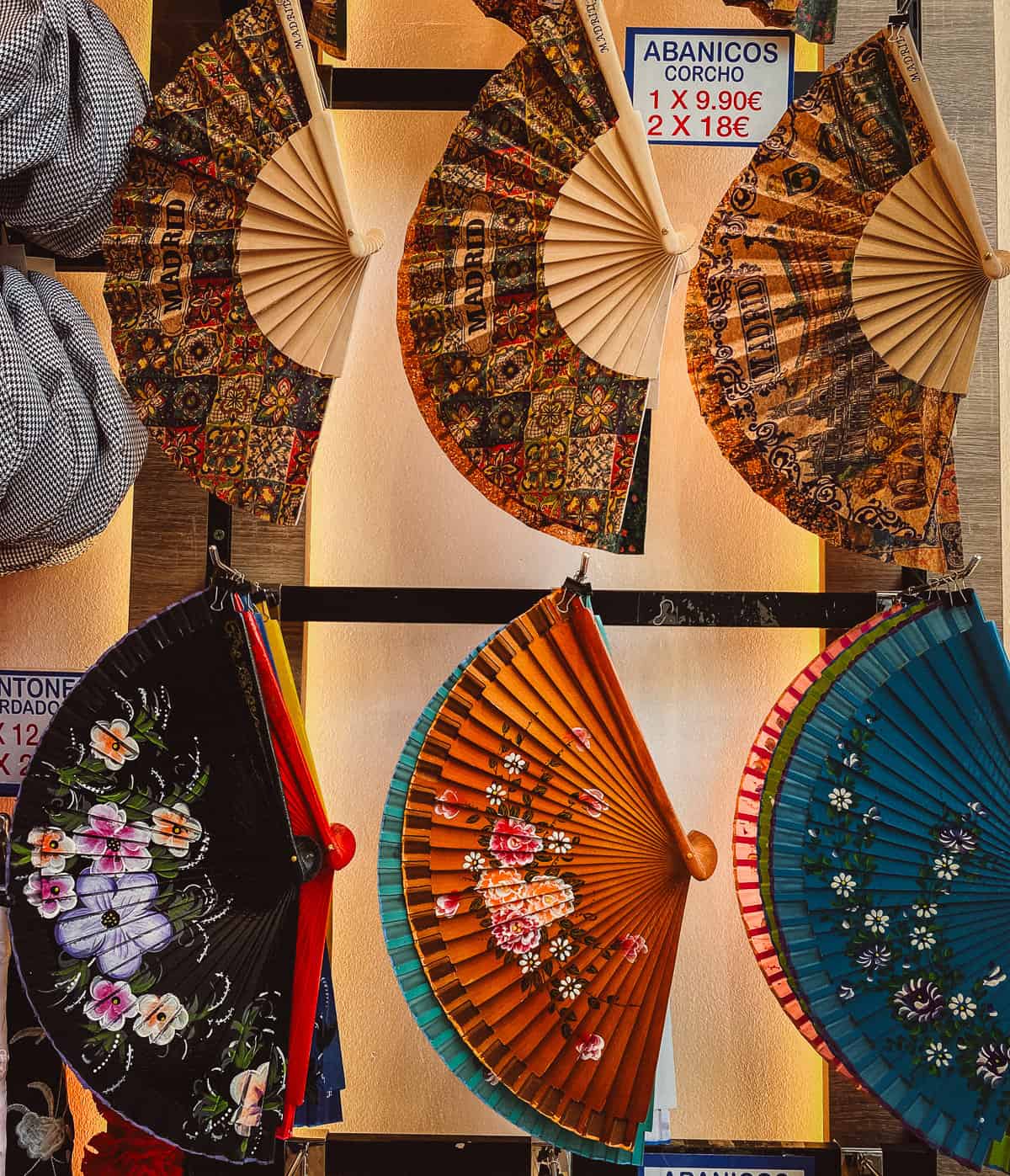 Colorful spanish hand fans displayed on a wall