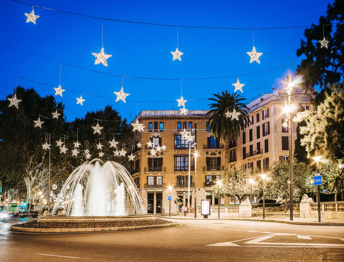 A plaza with a fountain and stars at Christmas in Mallorca