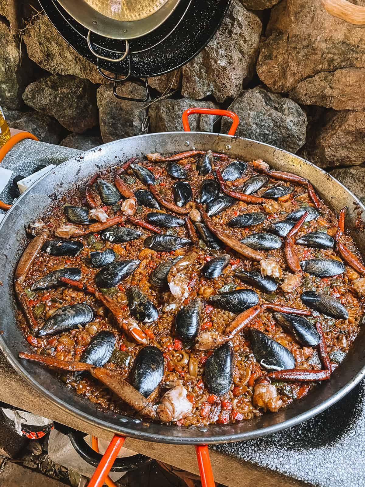 A large pot of seafood paella on a stove