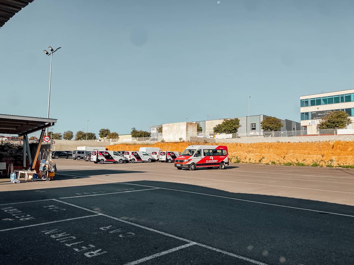 A rental car parking lot with a shuttle