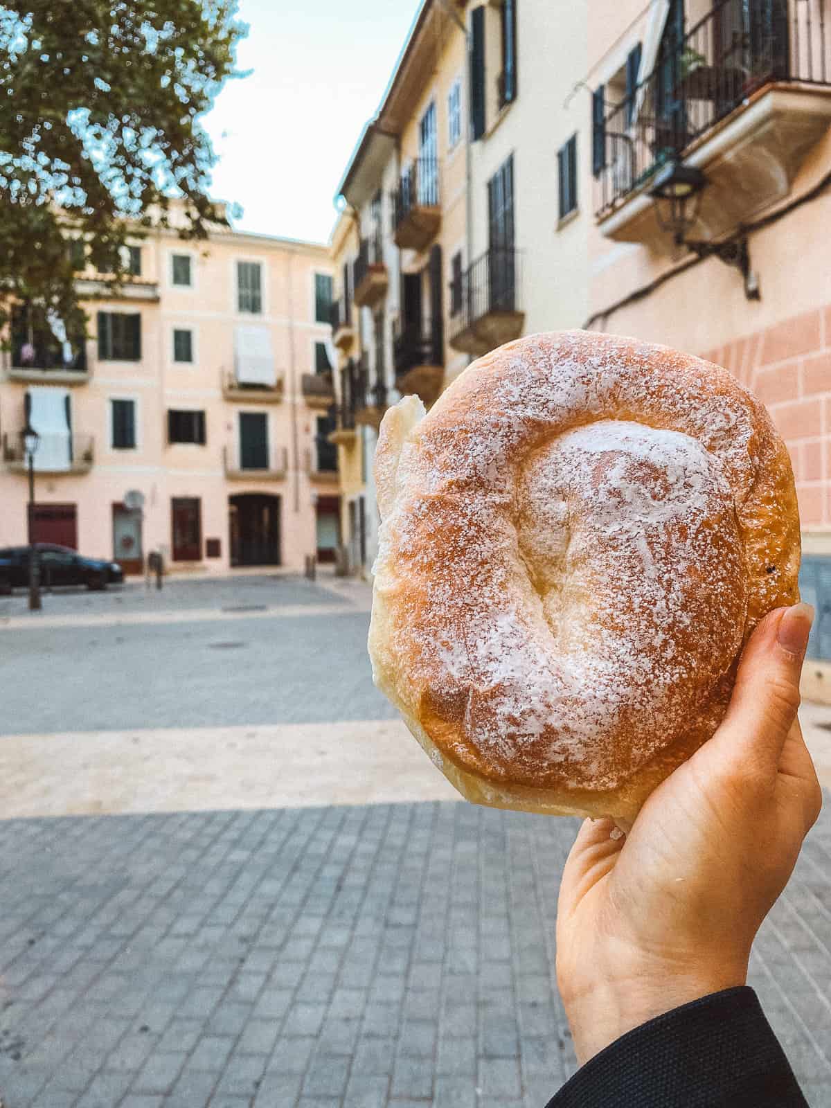 a spiral shaped ensaimada pastry in Mallorca covered with powdered sugar