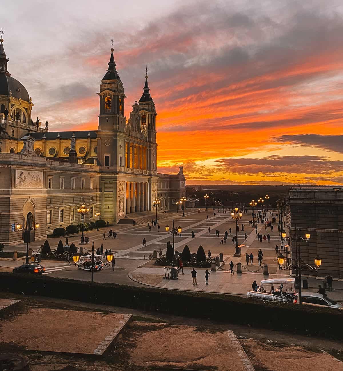 An orange and pink sunset in front of the palace in Madrid