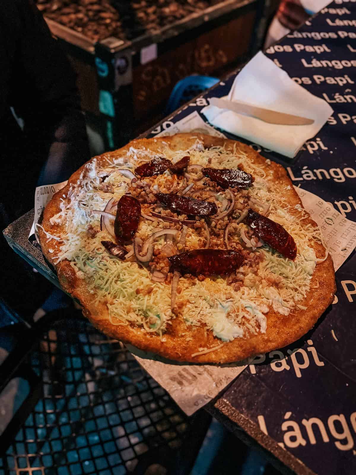 A Hungarian Langos which is fried dough topped with sour cream and cheese