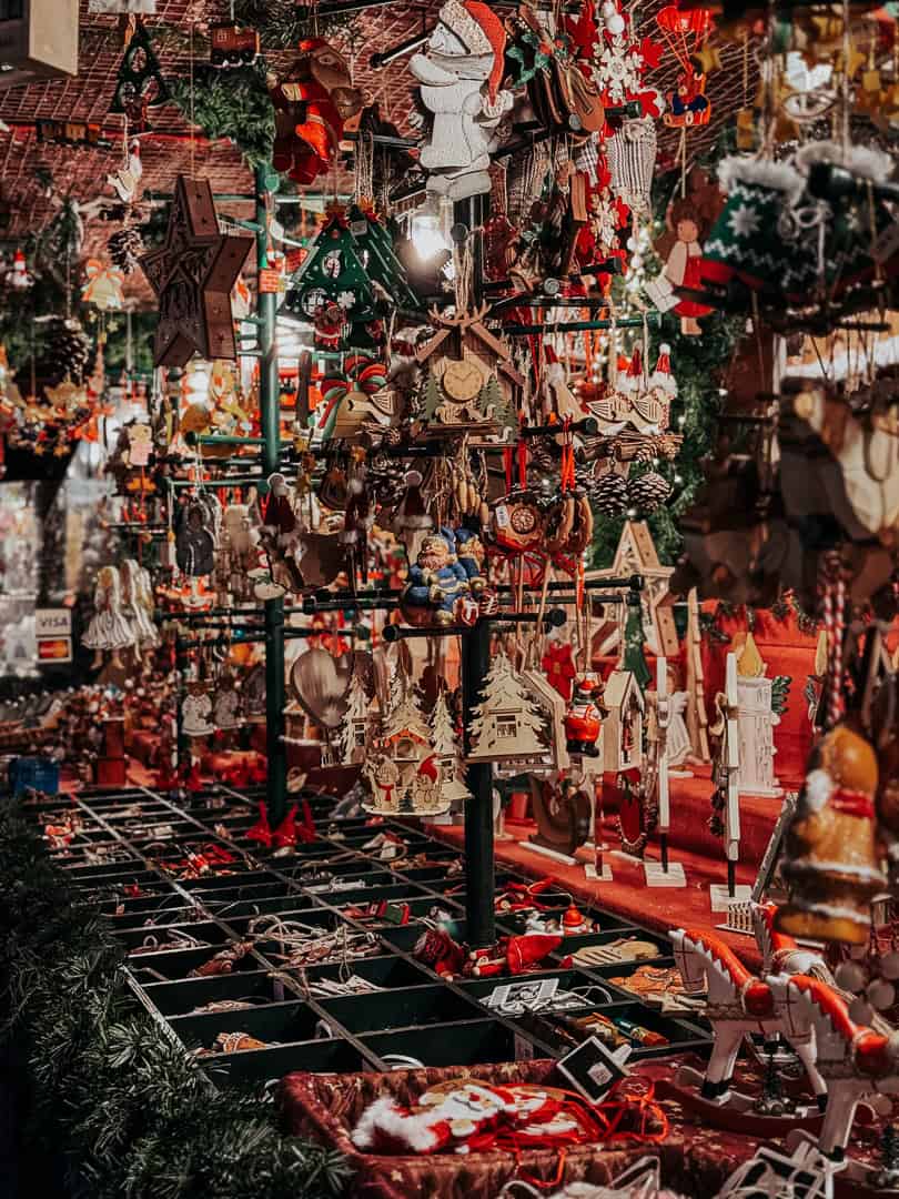 An assortment of colorful Christmas decorations and ornaments on display at a festive market stall