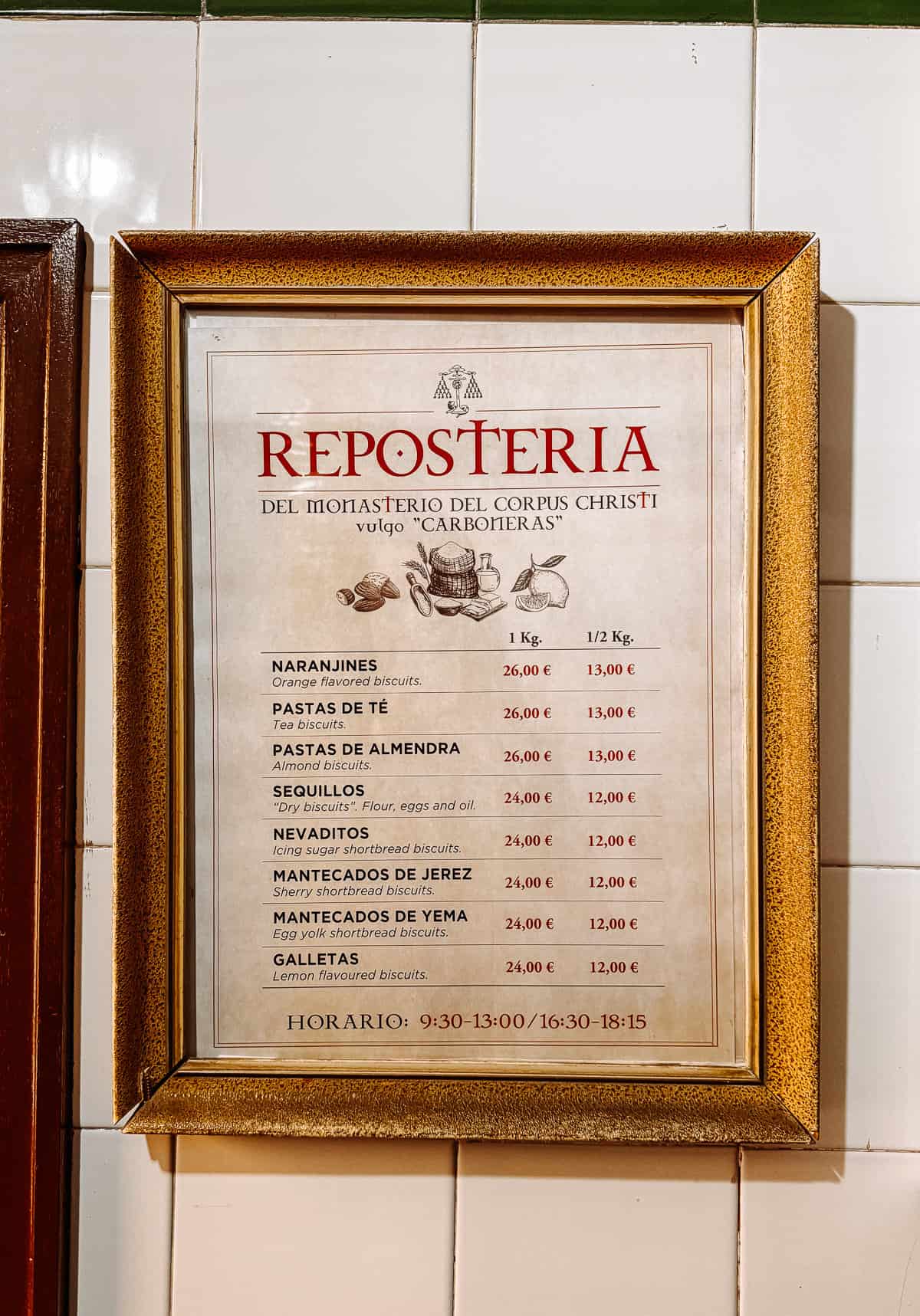 Framed price list on a tiled wall for 'REPOSTERIA DEL MONASTERIO DEL CORPUS CHRISTI vulgo 