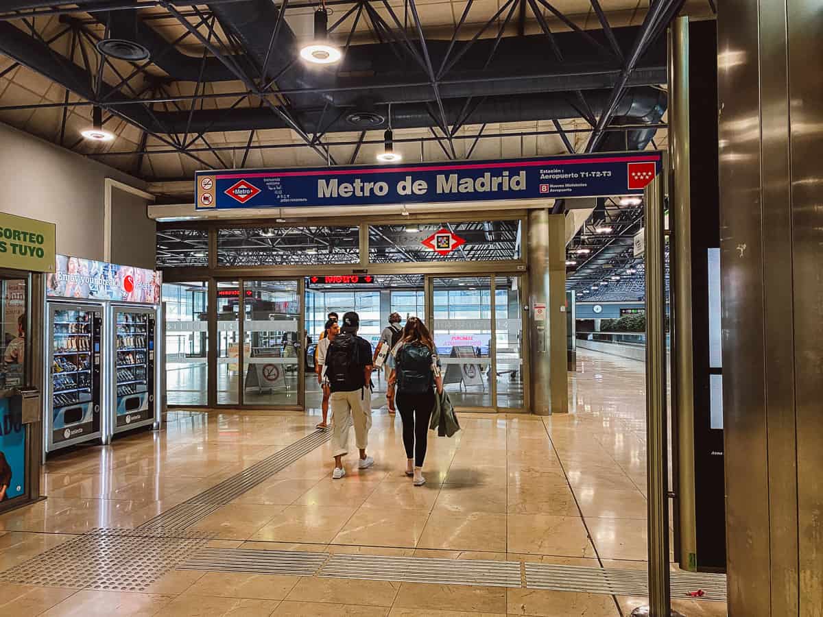 People walking into the metro at Madrid airport