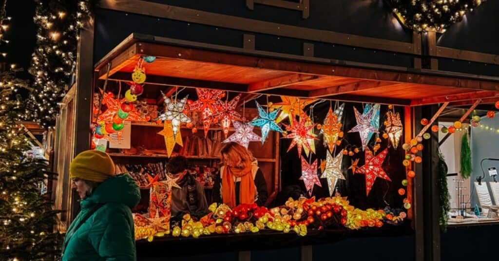 a Christmas market stall with paper stars for sale