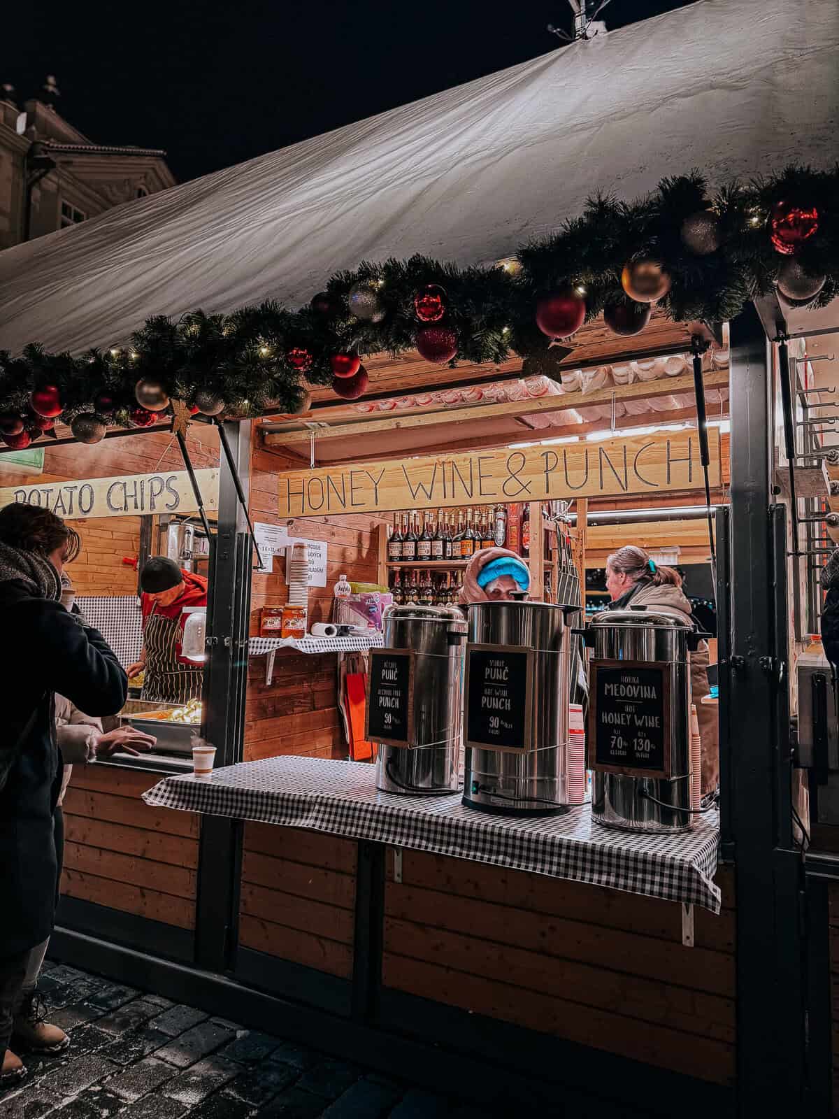 a wooden christmas market stall in Prague selling mead