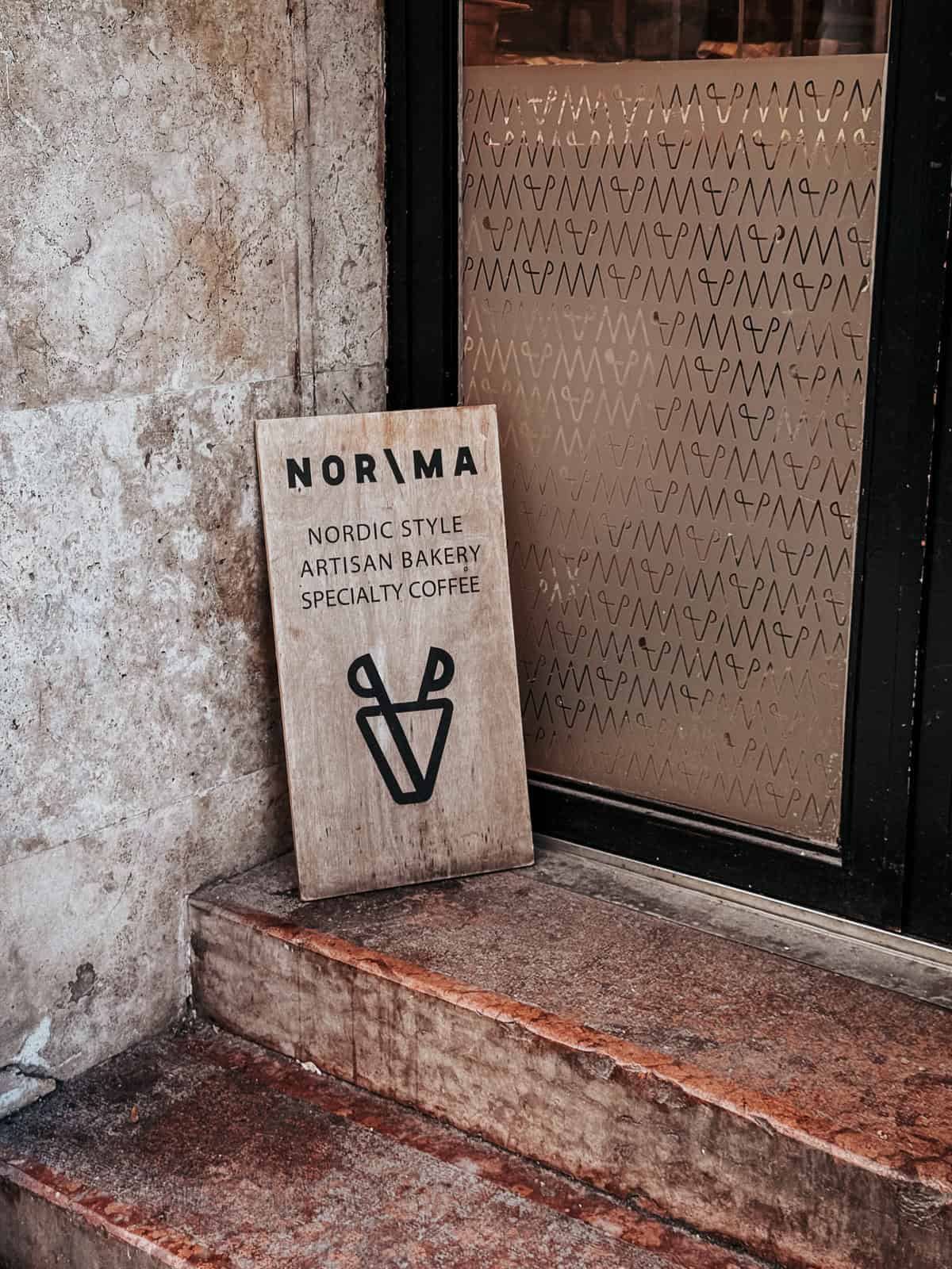 The entrance of Norma bakery with a signboard reading 