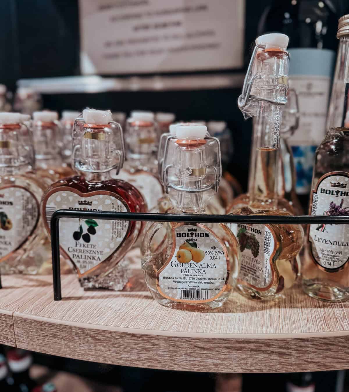 small bottles of palinka in glasses bottles on a souvenir shop shelf