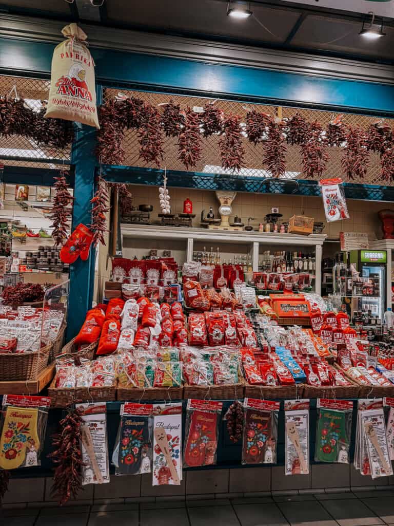 the market stall in budapest with dried peppers and bags of paprika hanging from the shelves