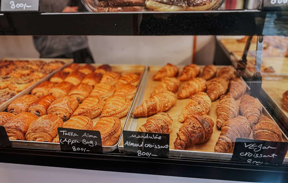 a tray of sad looking croissants in a bakery window