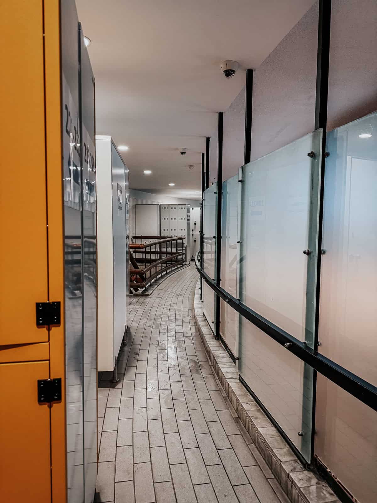 Hallway in the Gellért Thermal Bath featuring yellow lockers and tiled flooring.