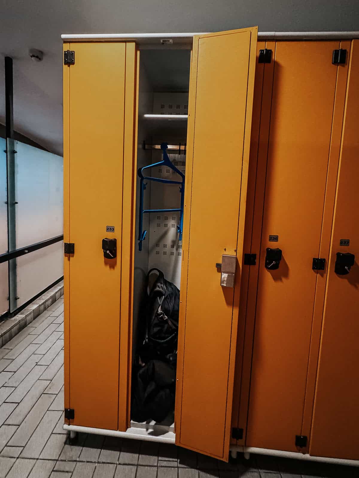 Open yellow locker in the Gellért Thermal Bath, showing a bag and clothes inside.