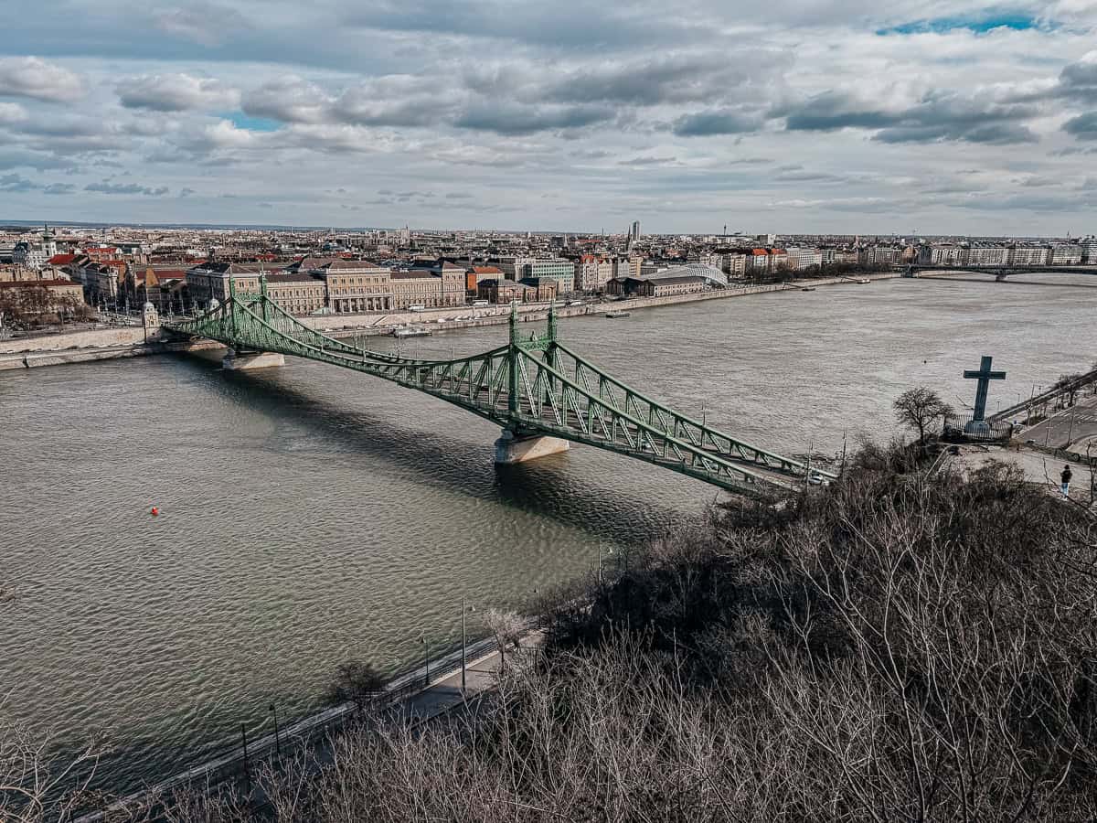 An aerial view of Liberty Bridge spanning across the Danube River in Budapest.