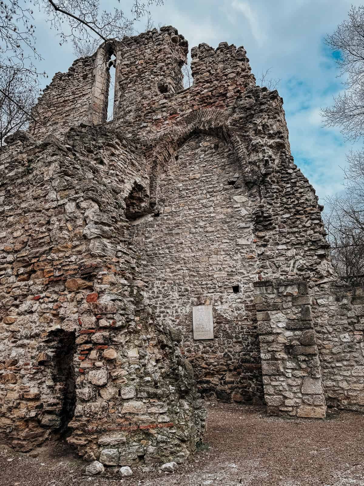 Ruins of an old stone structure with a partially cloudy sky in the background on Margaret Island.