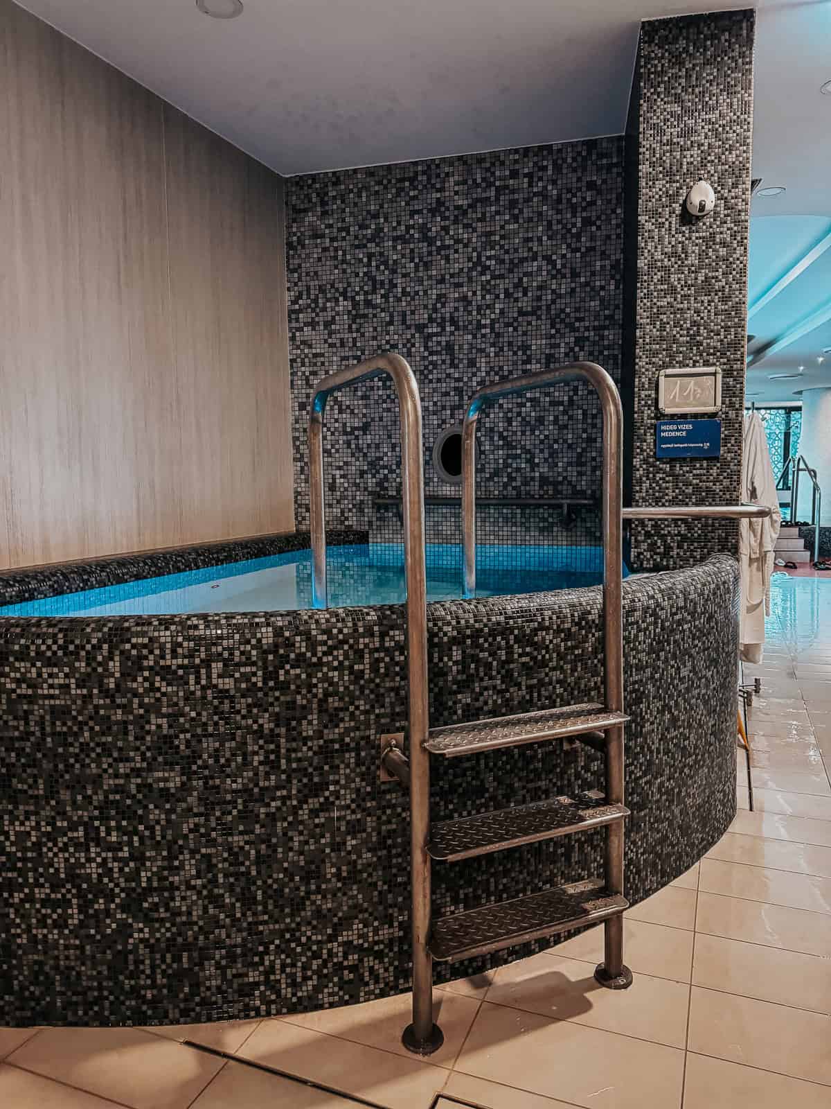 Image showing a small indoor pool with tiled walls and metal handrails at Rudas Gyógyfürdő (Rudas Baths), Budapest.