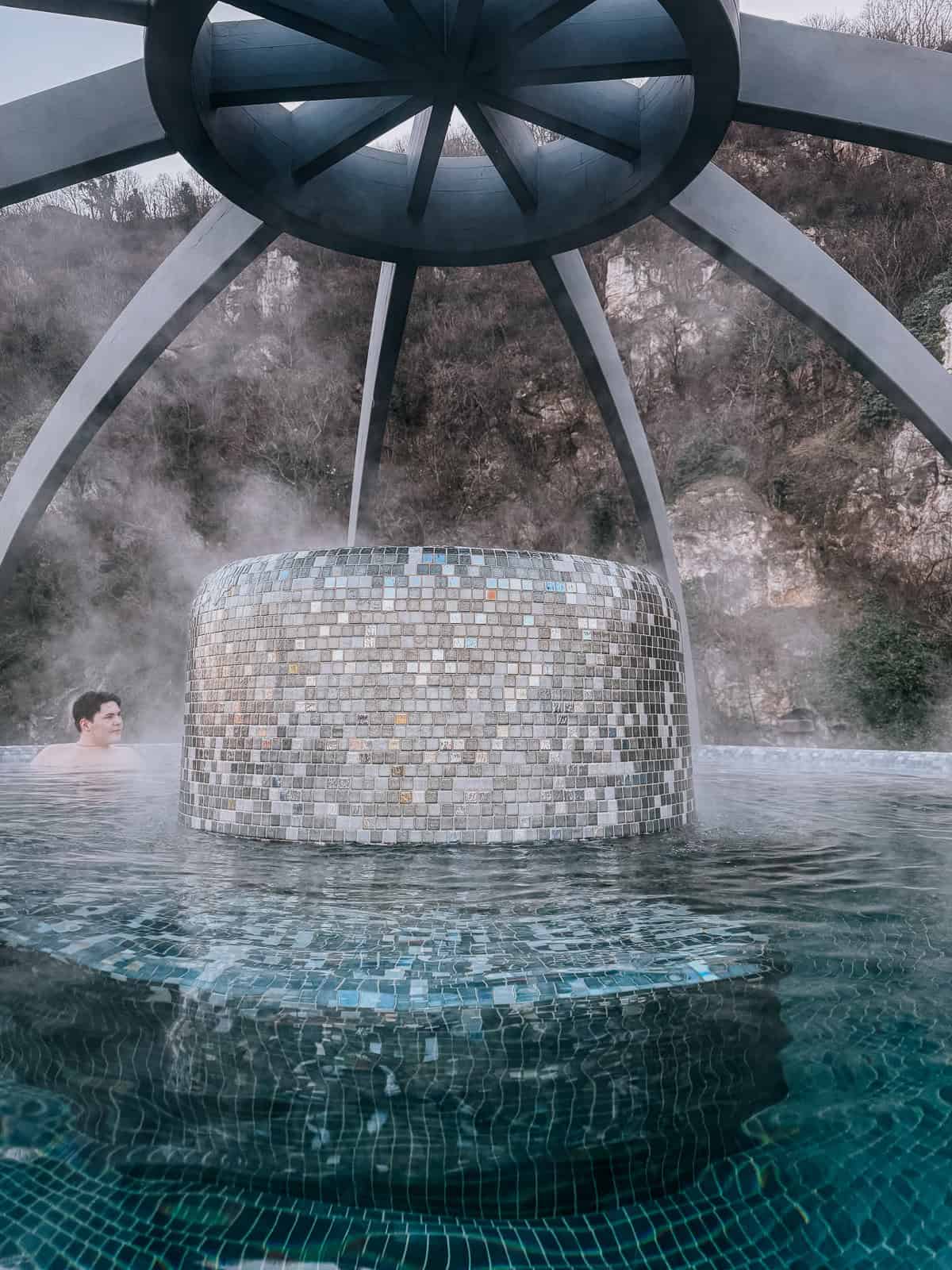 Image showing an outdoor thermal pool area with steps leading up to a covered structure at Rudas Gyógyfürdő (Rudas Baths), Budapest.