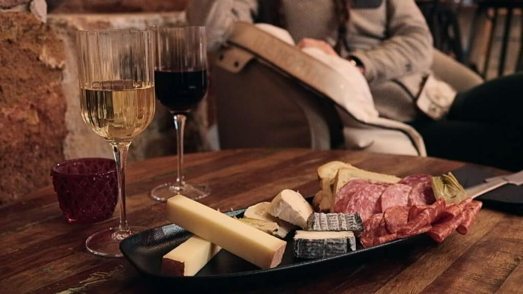 a plate of french cheese and wine with pate en croute