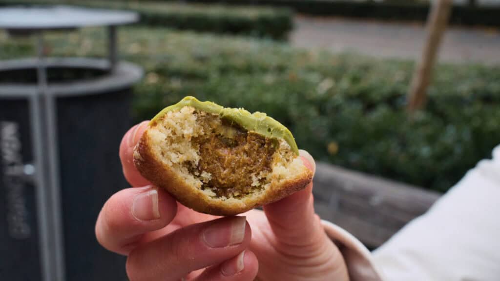 Stuffed pistachio madeleine from Miss Madeleine in Lyon, showing a moist crumb and rich nut filling