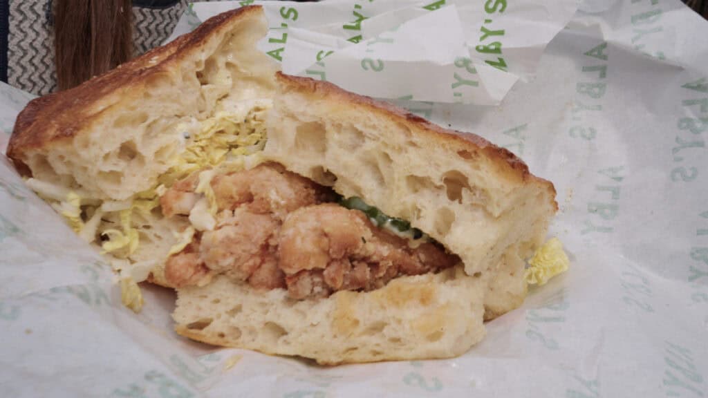 Crispy fried chicken sandwich on soft bread from a popular Edinburgh sandwich shop